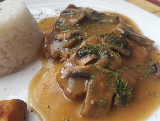 Porción de mano de piedra en salsa de hongos con arroz blanco
